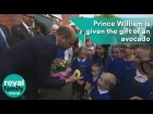 Prince William is given the gift of an avocado by a young boy